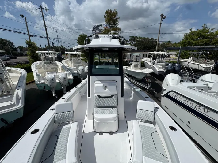  Yacht Photos Pics 2026 Blackfin 262 HB boat displayed among other boats under a cloudy sky.