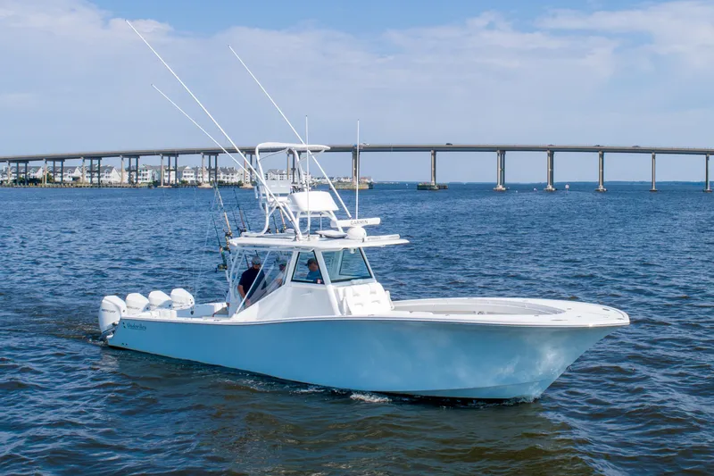 Reel Development Yacht Photos Pics 2022 Onslow Bay 41 TE boat cruising on open water near a bridge.
