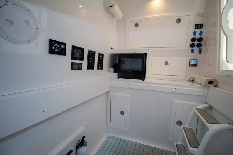Reel Development Yacht Photos Pics 2022 Onslow Bay 41 TE cabin interior with control panels and storage compartments.
