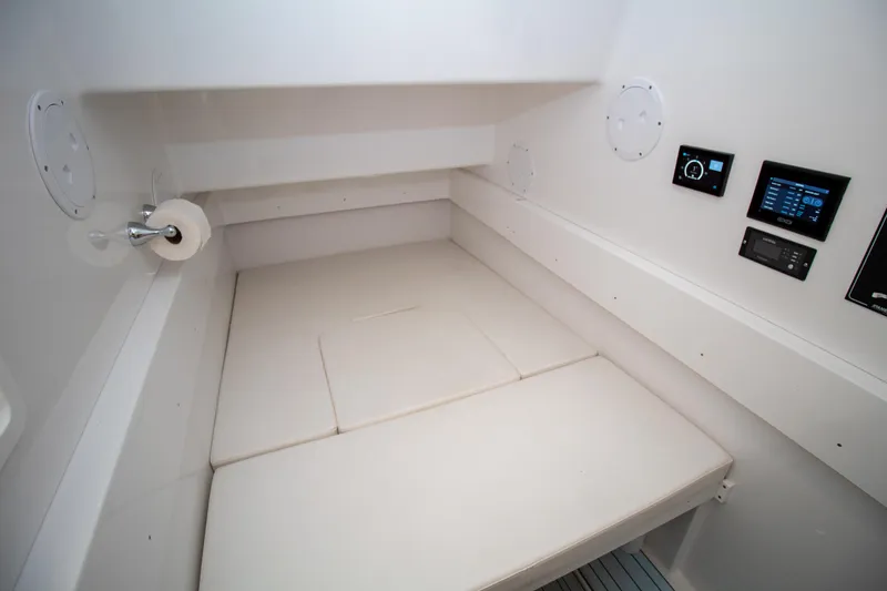 Reel Development Yacht Photos Pics 2022 Onslow Bay 41 TE cabin interior with cushioned seating and control panels.