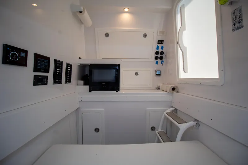 Reel Development Yacht Photos Pics 2022 Onslow Bay 41 TE boat interior with control panels and storage compartments.