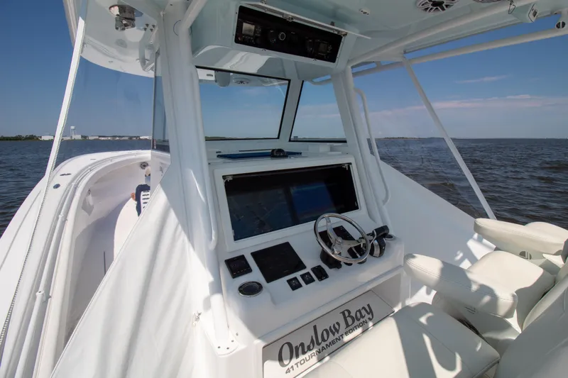 Reel Development Yacht Photos Pics Onslow Bay 41 TE 2022 boat interior with steering console on open water.