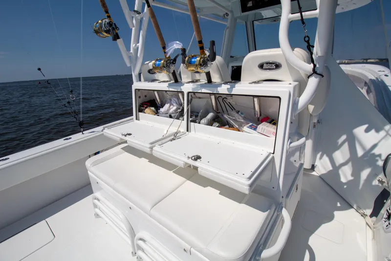 Reel Development Yacht Photos Pics Onslow Bay 41 TE 2022 fishing boat with open storage compartments and rods.