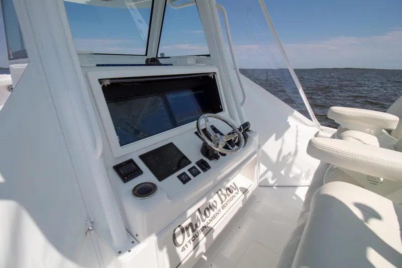 Reel Development Yacht Photos Pics 2022 Onslow Bay 41 TE boat cockpit with steering wheel and navigation system.