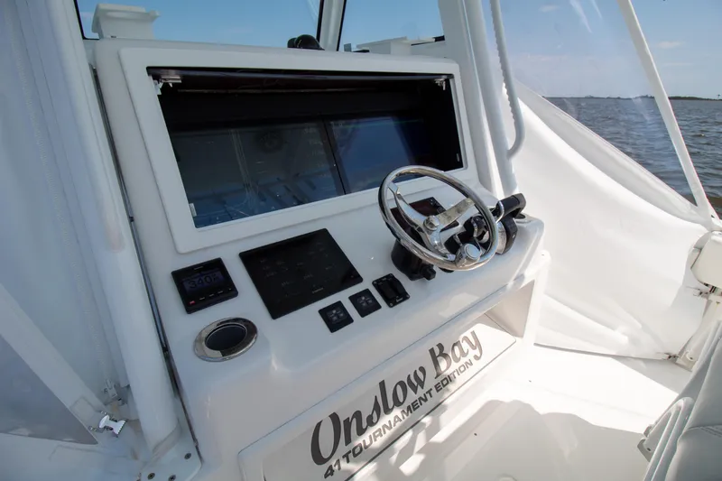 Reel Development Yacht Photos Pics 2022 Onslow Bay 41 TE boat dashboard with steering wheel and controls.