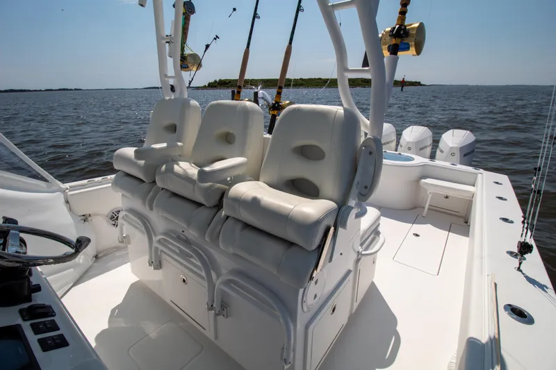 Reel Development Yacht Photos Pics 2022 Onslow Bay 41 TE boat interior with plush seating and fishing rods.