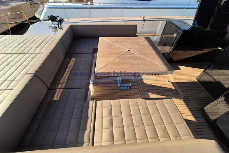  Yacht Photos Pics Luxurious seating area on 2022 Pardo Yachts 50 with wooden table and cushioned benches.