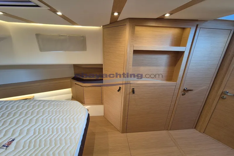  Yacht Photos Pics Luxurious interior of 2022 Pardo Yachts 50, featuring modern wood cabinetry and cozy sleeping area.