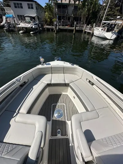  Yacht Photos Pics 2024 Sea Ray SLX 310 OB boat with spacious seating, docked near waterfront homes.