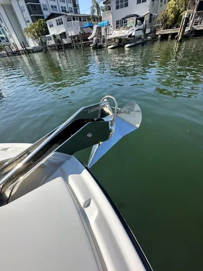  Yacht Photos Pics 2024 Sea Ray SLX 310 OB boat anchor in a marina setting.