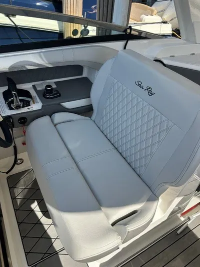  Yacht Photos Pics 2024 Sea Ray SLX 310 OB boat interior with luxurious seating and control panel.