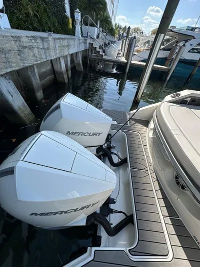  Yacht Photos Pics 2024 Sea Ray SLX 310 OB with dual Mercury outboard engines docked at marina.