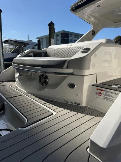  Yacht Photos Pics 2024 Sea Ray SLX 310 OB boat with sleek design and modern features, docked under clear skies.