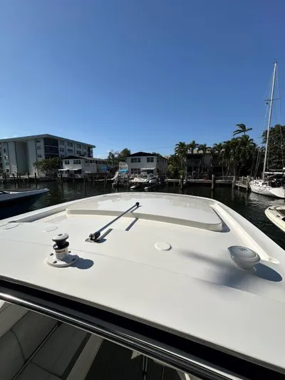  Yacht Photos Pics 2024 Sea Ray SLX 310 OB boat docked in a sunny marina setting.