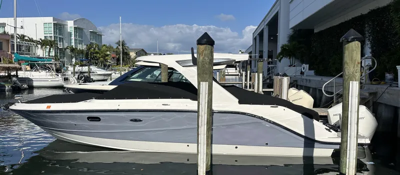  Yacht Photos Pics 2024 Sea Ray SLX 310 OB boat docked at marina, side view.