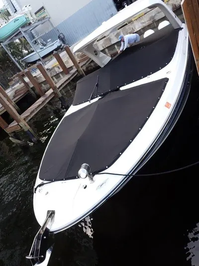  Yacht Photos Pics 2024 Sea Ray SLX 310 OB boat docked with black covers, side view.