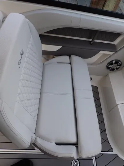  Yacht Photos Pics 2024 Sea Ray SLX 310 OB boat interior with white cushioned seating.