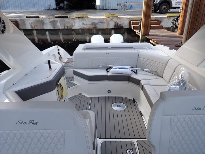  Yacht Photos Pics 2024 Sea Ray SLX 310 OB boat with luxurious seating and sleek design at a dock.