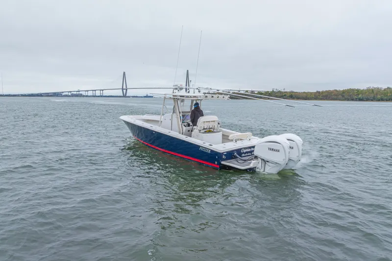  Yacht Photos Pics 2008 Jupiter 31 FS boat with twin Yamaha engines on open water near a bridge.