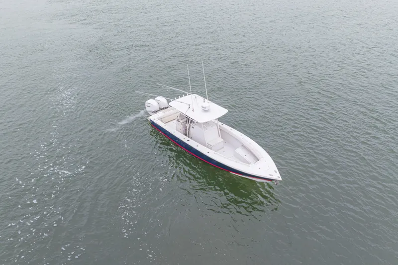  Yacht Photos Pics 2008 Jupiter 31 FS boat cruising on open water, aerial view.