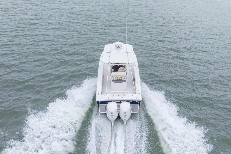  Yacht Photos Pics 2008 Jupiter 31 FS boat cruising on open water, rear view with twin engines.