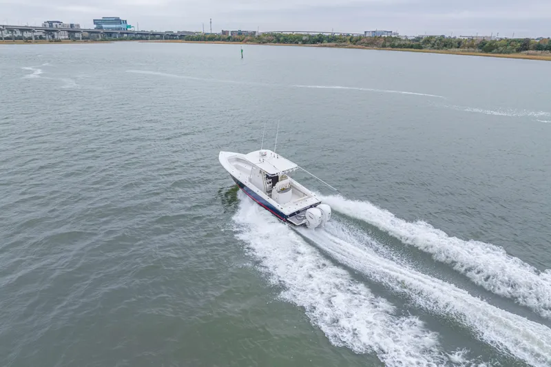 Yacht Photos Pics Aerial view of 2008 Jupiter 31 FS boat cruising on a calm river.