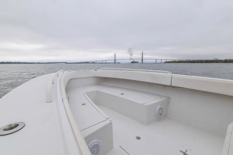  Yacht Photos Pics 2008 Jupiter 31 FS boat on water with bridge and ship in background.