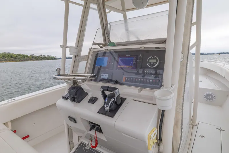  Yacht Photos Pics 2008 Jupiter 31 FS boat helm with modern navigation equipment on calm waters.