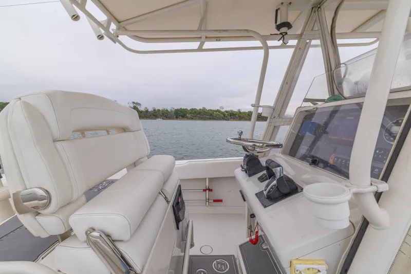 Yacht Photos Pics 2008 Jupiter 31 FS boat cockpit with steering wheel and navigation controls.