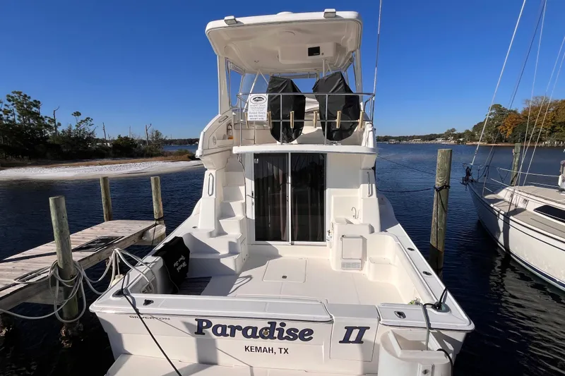  Yacht Photos Pics 2001 Silverton 42C yacht docked at marina, named "Paradise II," in Kemah, Texas.