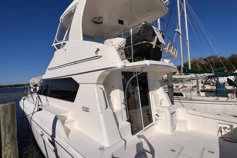  Yacht Photos Pics 2001 Silverton 42C yacht docked at marina under clear blue sky.