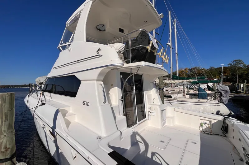  Yacht Photos Pics 2001 Silverton 42C yacht docked at marina under clear blue sky.