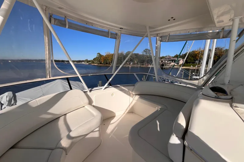  Yacht Photos Pics 2001 Silverton 42C yacht interior with white seating, overlooking serene waterfront and trees.