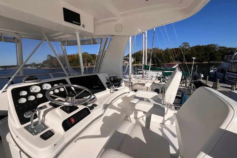  Yacht Photos Pics 2001 Silverton 42C yacht helm with steering wheel, gauges, and marina view.