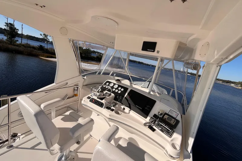  Yacht Photos Pics 2001 Silverton 42C yacht helm with modern navigation equipment, overlooking serene waters.
