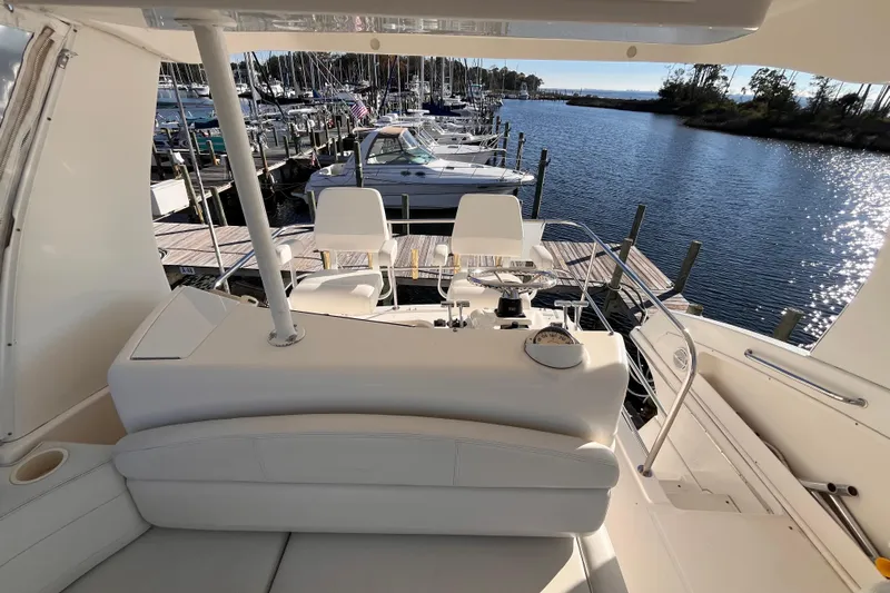  Yacht Photos Pics 2001 Silverton 42C yacht interior with helm, docked at marina under sunny skies.