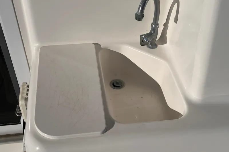  Yacht Photos Pics 2001 Silverton 42C boat sink with faucet and cover, white finish.