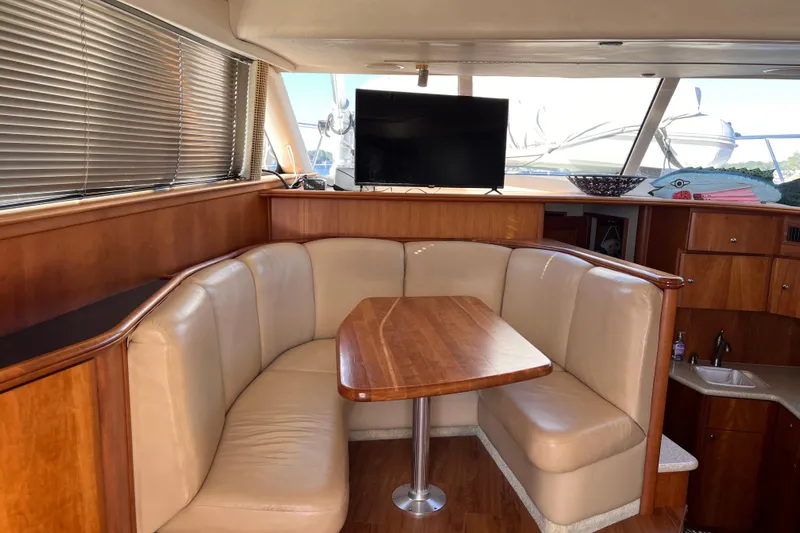  Yacht Photos Pics Luxurious interior of 2001 Silverton 42C yacht with plush seating and wooden table.