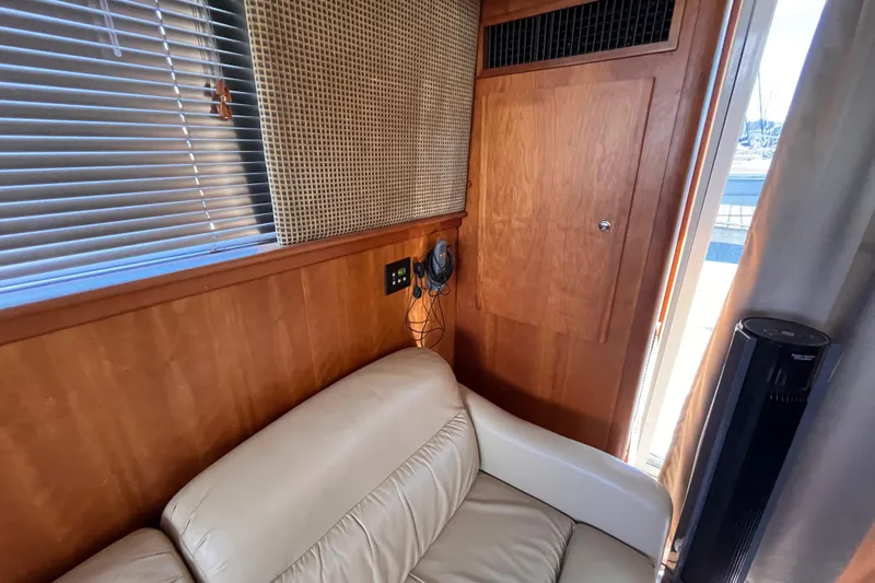  Yacht Photos Pics Interior of 2001 Silverton 42C yacht with beige leather seating and wooden paneling.