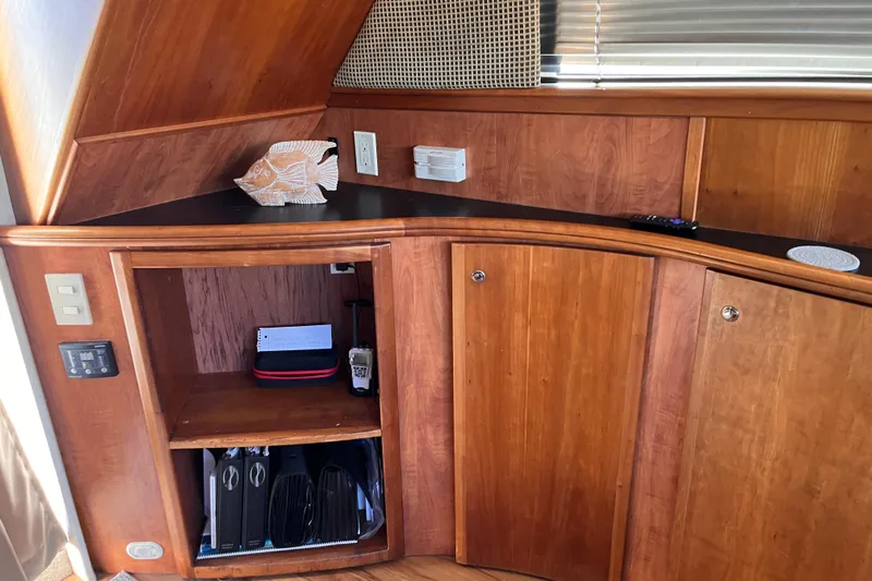  Yacht Photos Pics 2001 Silverton 42C yacht interior with wooden cabinetry and decorative fish sculpture.