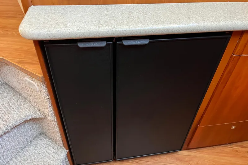  Yacht Photos Pics 2001 Silverton 42C yacht interior with Nova Kool refrigerator and wooden cabinetry.