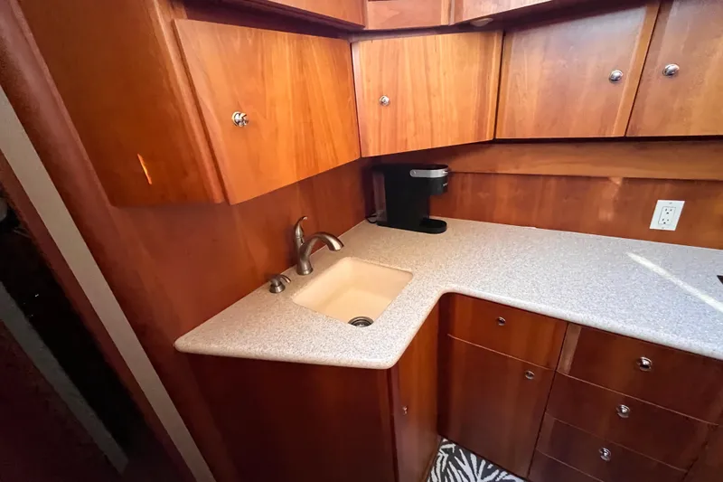  Yacht Photos Pics 2001 Silverton 42C yacht kitchen with wooden cabinets and countertop sink.