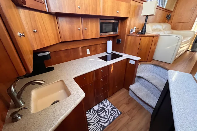  Yacht Photos Pics Interior of 2001 Silverton 42C yacht with modern kitchen and cozy seating area.