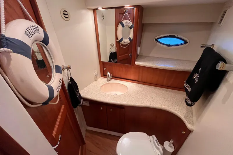  Yacht Photos Pics Luxurious 2001 Silverton 42C yacht bathroom with elegant wood accents and nautical decor.
