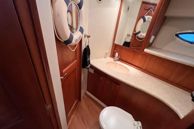  Yacht Photos Pics 2001 Silverton 42C yacht bathroom with wooden cabinetry and nautical decor.