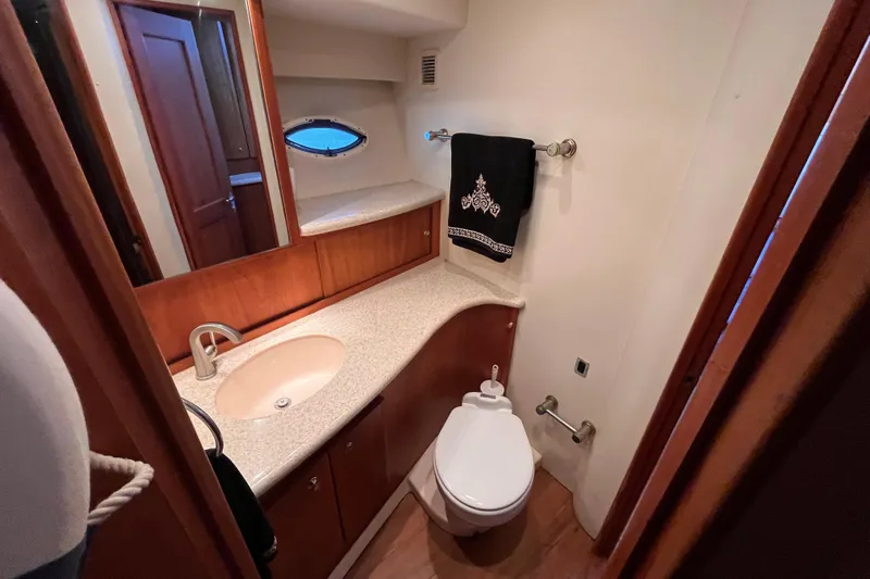  Yacht Photos Pics Luxurious bathroom in 2001 Silverton 42C yacht with elegant wood cabinetry and modern fixtures.