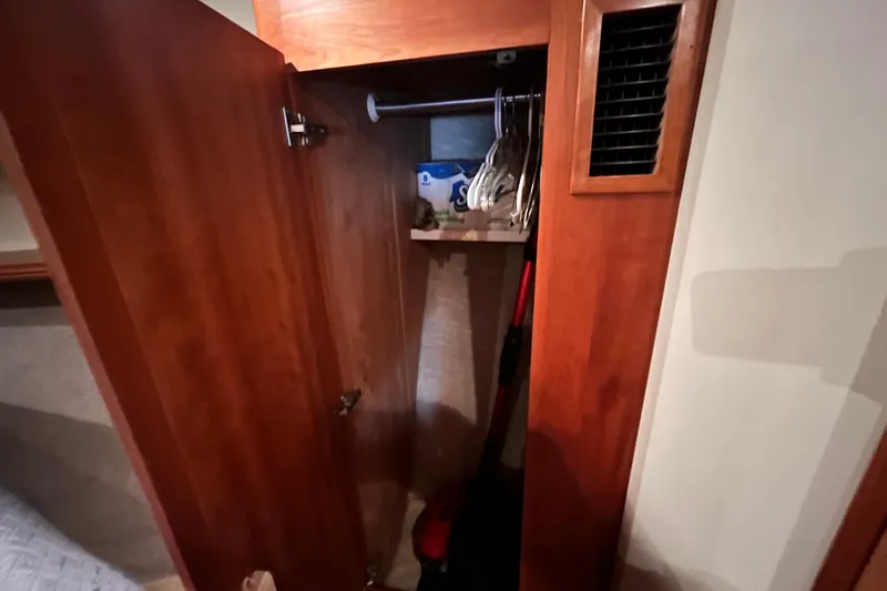  Yacht Photos Pics Open wooden closet in 2001 Silverton 42C yacht, showing hangers and storage items.