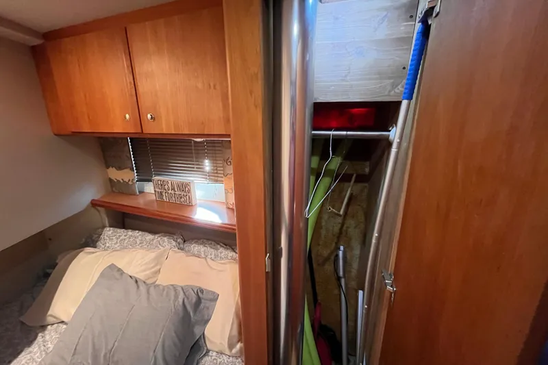  Yacht Photos Pics Cozy cabin interior of 2001 Silverton 42C with bed, wooden cabinets, and closet space.