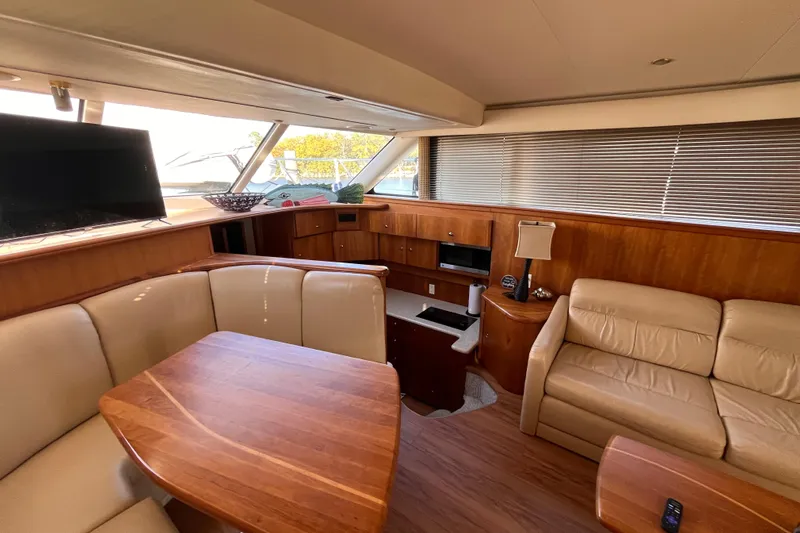  Yacht Photos Pics Interior of 2001 Silverton 42C yacht with leather seating, wooden table, and modern amenities.