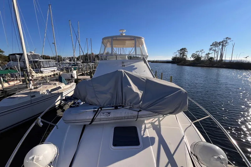  Yacht Photos Pics 2001 Silverton 42C yacht docked at marina, sunny day, calm water, covered equipment on deck.